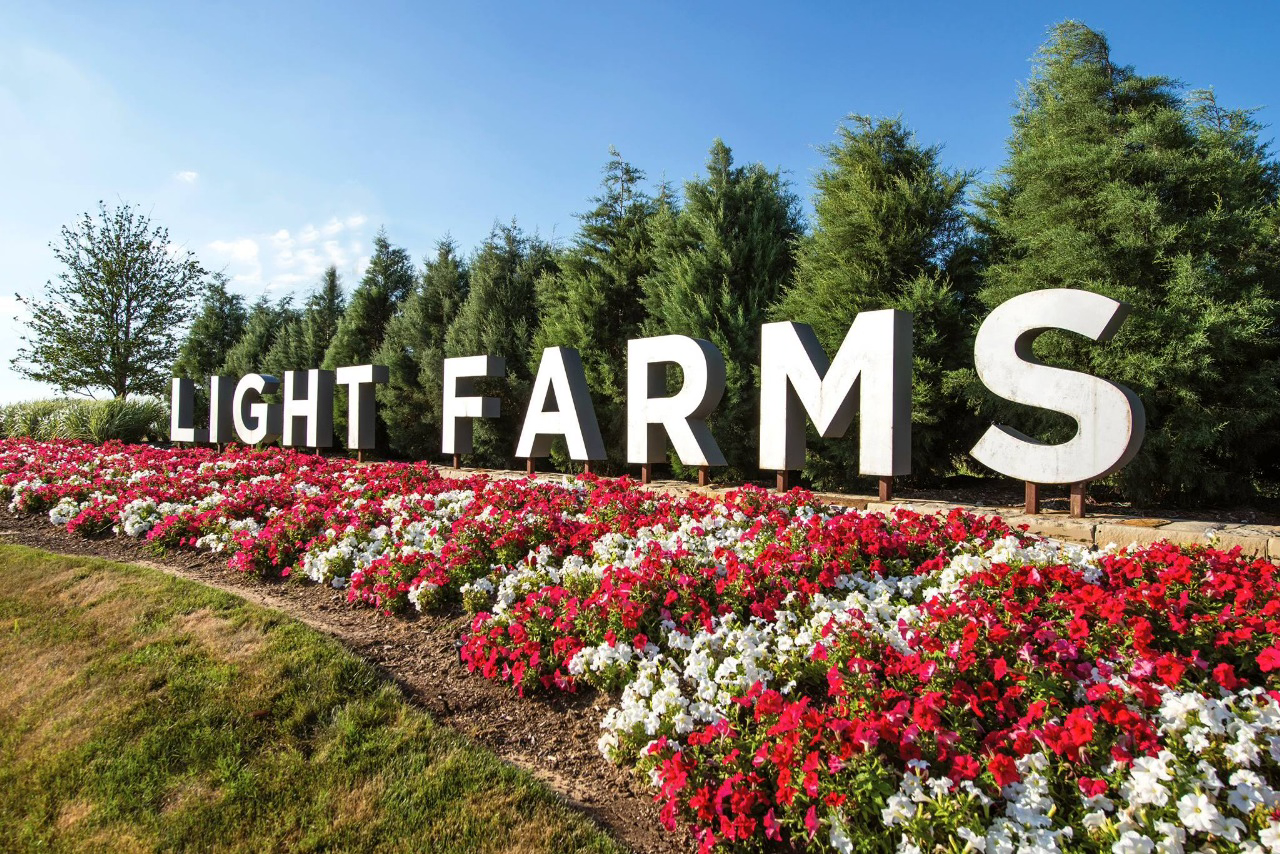Light Farms community entrance with flowers