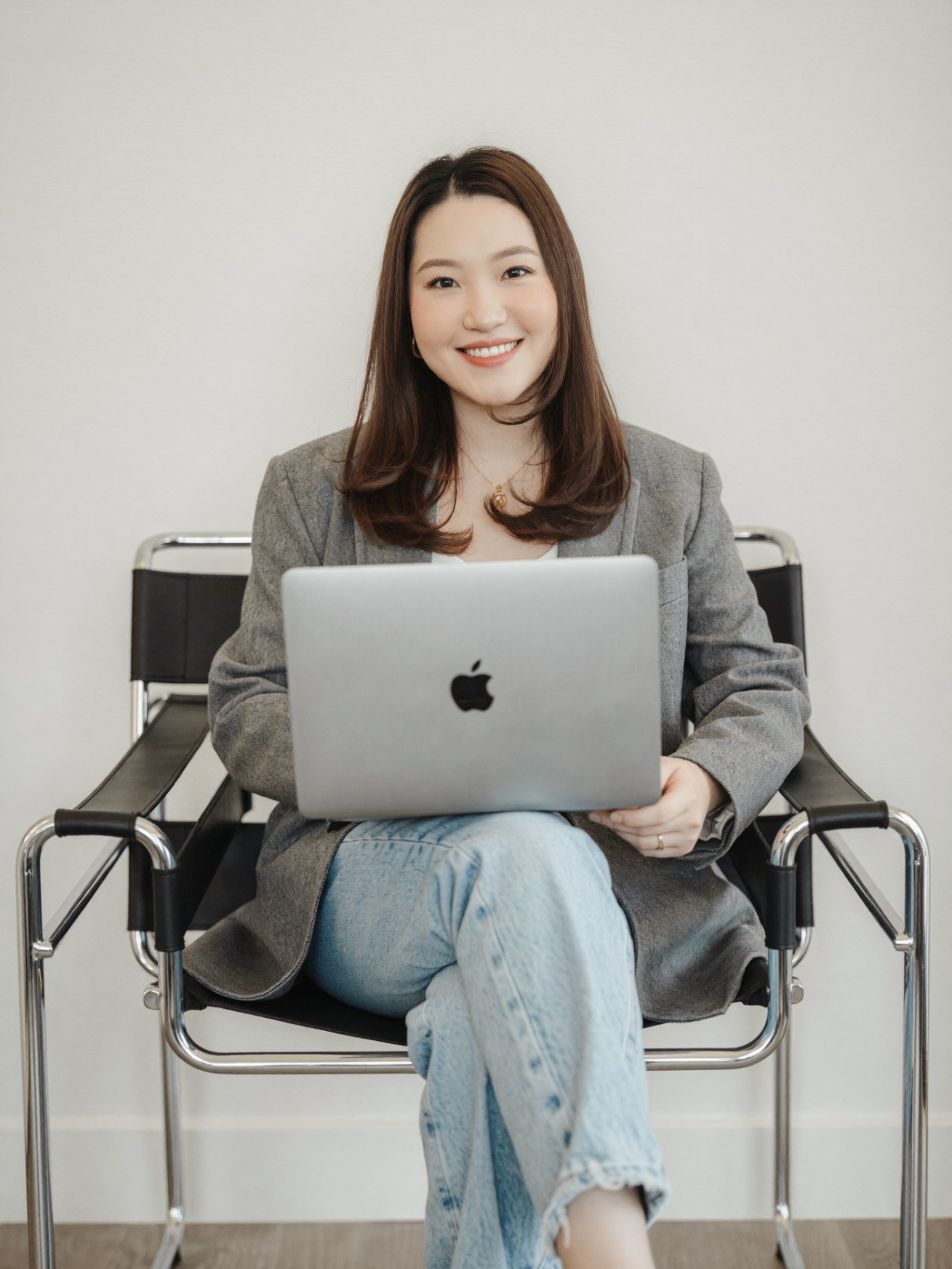 Raven Mok, real estate agent and Lighthaus University founder, working on her laptop